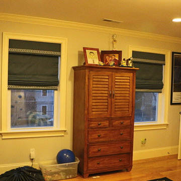 Cordless Roman shades with matching valance and trim detail
