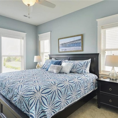 Example of a mid-sized beach style guest carpeted bedroom design in Other with blue walls and no fireplace