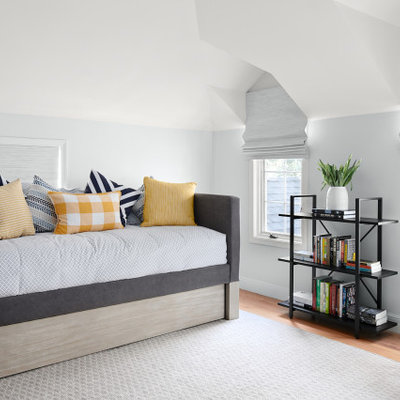 Example of a mid-sized transitional guest medium tone wood floor and brown floor bedroom design in San Francisco with gray walls