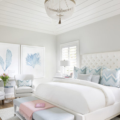 Bedroom - coastal medium tone wood floor and brown floor bedroom idea in Miami with gray walls