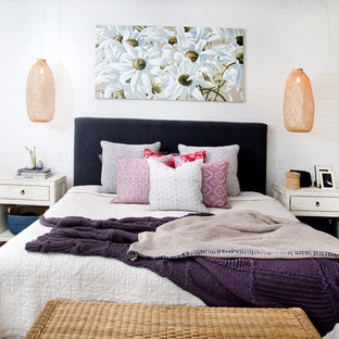 Photo of an eclectic bedroom in Sydney with white walls, carpet and brown floor.