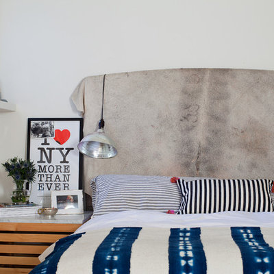 Example of an eclectic bedroom design with white walls