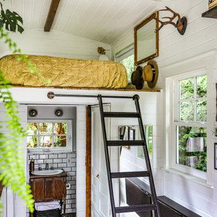 Foto de dormitorio tipo loft, campestre, con paredes blancas, suelo de madera oscura y suelo marrón