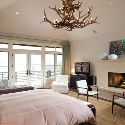 Trendy bedroom photo in New York with a standard fireplace