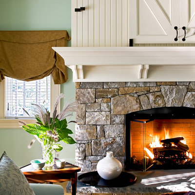 Inspiration for a timeless bedroom remodel in New York with green walls, a stone fireplace and a standard fireplace