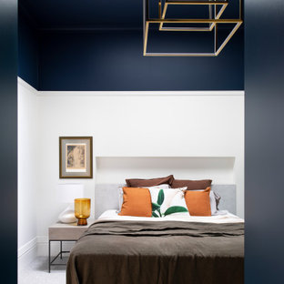 Photo of a contemporary bedroom in Melbourne with white walls, carpet and grey floor.