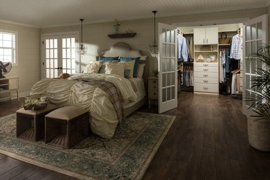 Ejemplo de dormitorio principal de estilo de casa de campo de tamaño medio sin chimenea con suelo de madera en tonos medios, paredes beige y suelo marrón