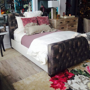 Example of a mid-sized cottage chic guest dark wood floor and brown floor bedroom design in Other with no fireplace