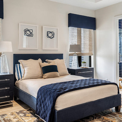 Bedroom - coastal guest light wood floor bedroom idea in Other with white walls and no fireplace