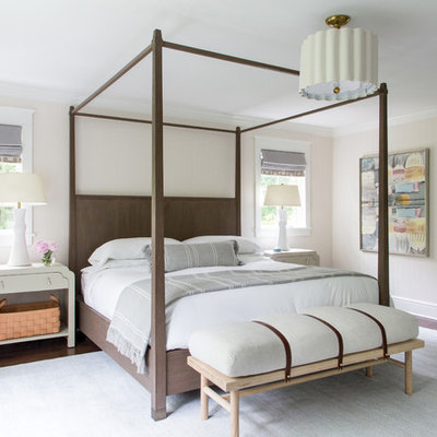 Transitional dark wood floor and brown floor bedroom photo in New York with beige walls