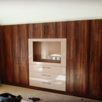 Dark walnut combined with high gloss cappuccino. Wide screen TV featuring in thi