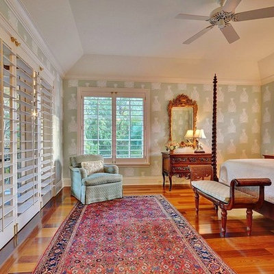 Bedroom - tropical medium tone wood floor bedroom idea in Miami with multicolored walls