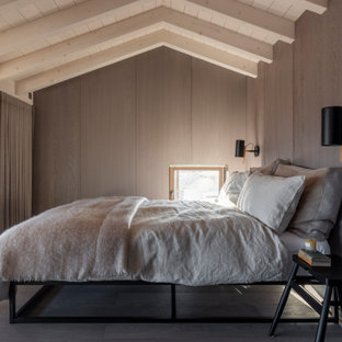 Inspiration for a beach style bedroom in Essex with brown walls, dark hardwood flooring, brown floors, exposed beams, a vaulted ceiling, a wood ceiling and wood walls.