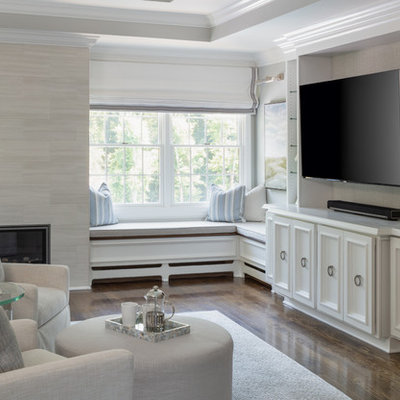 Inspiration for a huge transitional master medium tone wood floor and brown floor bedroom remodel in New York with gray walls, a standard fireplace and a tile fireplace
