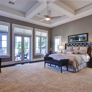 Large trendy master dark wood floor bedroom photo in Miami with beige walls