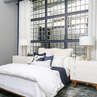 Foto de dormitorio industrial, de tamaño medio, sin chimenea, con paredes azules