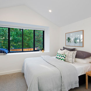Contemporary guest bedroom in Sydney with white walls, carpet, no fireplace and beige floor.