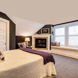 Modelo de dormitorio principal, de estilo americano, pequeño, con paredes grises, suelo de madera oscura, chimenea de esquina y marco de chimenea de baldosas y/o azulejos