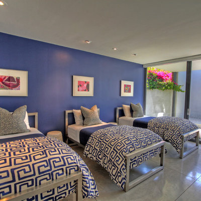 Example of a trendy guest bedroom design in Orange County with blue walls