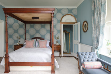 Design ideas for a classic bedroom in Dorset with blue walls, dark hardwood flooring, brown floors and wallpapered walls.