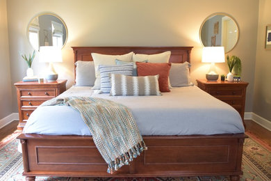 Mid-sized trendy master medium tone wood floor and multicolored floor bedroom photo in Atlanta with beige walls