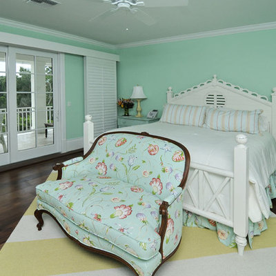 Example of a classic dark wood floor bedroom design in Miami with green walls and no fireplace