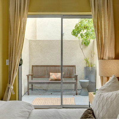 Example of a trendy bedroom design in San Diego with yellow walls