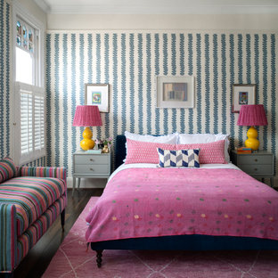 Traditional guest bedroom in London with multi-coloured walls, dark hardwood flooring, no fireplace, brown floors and wallpapered walls.