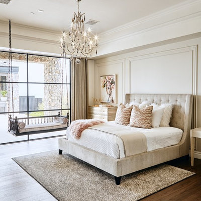 Example of a transitional dark wood floor and brown floor bedroom design in Phoenix with beige walls
