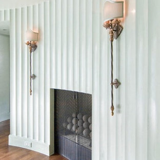 Inspiration for a large 1950s master medium tone wood floor and brown floor bedroom remodel in Charlotte with green walls and a standard fireplace