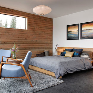 Imagen de dormitorio industrial con suelo de cemento y suelo gris