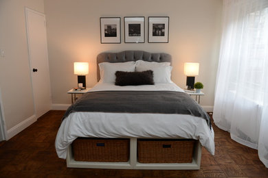 Example of a mid-sized transitional master medium tone wood floor and brown floor bedroom design in New York with white walls