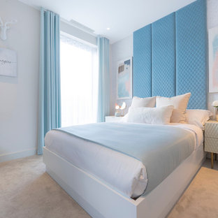 Inspiration for a medium sized bohemian bedroom in London with white walls, carpet, no fireplace and beige floors.