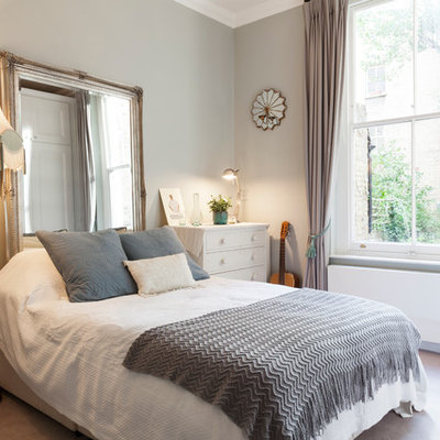 Eclectic carpeted bedroom photo in London with gray walls