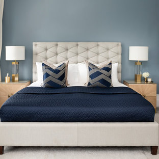 Design ideas for a contemporary master bedroom in London with blue walls, carpet and beige floors.