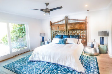 Imagen de dormitorio principal ecléctico de tamaño medio con paredes grises, suelo de madera clara y suelo beige