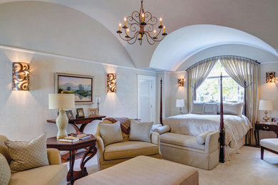 Vaulted ceiling master bedroom with custom lighting and sitting area