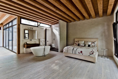 Bedroom - rustic master medium tone wood floor bedroom idea in Montreal with beige walls