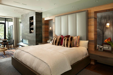 Contemporary bedroom in Minneapolis with dark hardwood flooring.