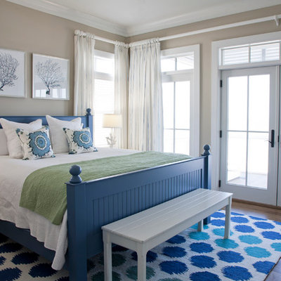 Inspiration for a coastal master medium tone wood floor bedroom remodel in Charleston with beige walls