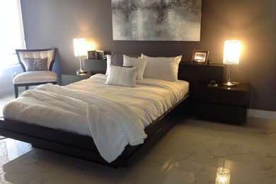Example of a trendy master marble floor bedroom design in San Diego with gray walls and no fireplace