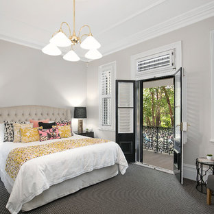 Design ideas for a mid-sized transitional master bedroom in Newcastle - Maitland with beige walls, carpet, black floor and no fireplace.