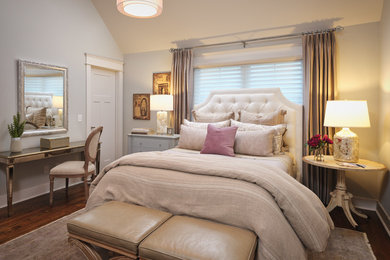 Example of a mid-sized classic guest medium tone wood floor and brown floor bedroom design in Other with gray walls