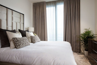 Design ideas for a small contemporary master bedroom in London with beige walls and carpet.