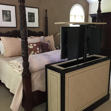 end of bed leather studded TV lift cabinet by Cabinet Tronix.. in up position.