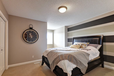 Inspiration for a mid-sized contemporary guest carpeted and beige floor bedroom remodel in Calgary with beige walls