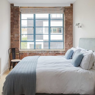 Photo of an industrial bedroom in London with white walls, carpet and beige floors.