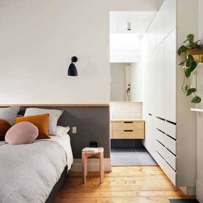 Bedroom - small contemporary master brown floor and medium tone wood floor bedroom idea in Melbourne with white walls and a standard fireplace