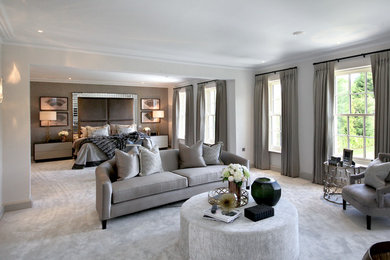Inspiration for an expansive contemporary master bedroom in Surrey with white walls, carpet and grey floors.