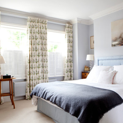 Bedroom - mid-sized traditional master carpeted and beige floor bedroom idea in London with blue walls